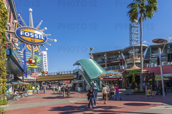 Shoppers and park guests walk through Universal's City Walk in Orlando, Florida, USA, North America
