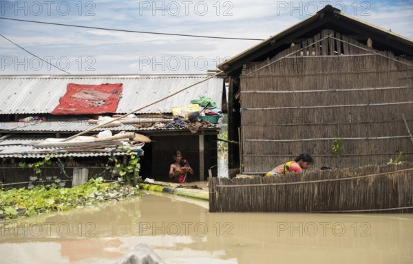 Morigaon, India. 4 July 2024. Residents in their flooded house, in a flood affected village in