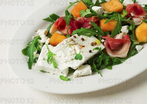 Salad, melon with prosciutto, arugula, and cheese, summer salad, vegetarian, homemade, no people