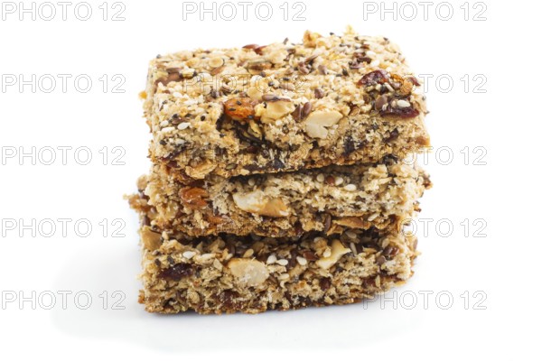 Homemade granola from oat flakes, dates, dried apricots, raisins, nuts isolated on white background