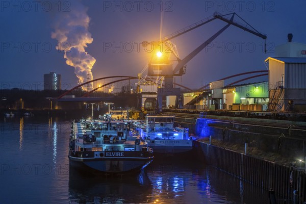 Cargo ships and cranes in Essen city harbour, on the Rhine-Herne Canal, motorway bridge of the A42