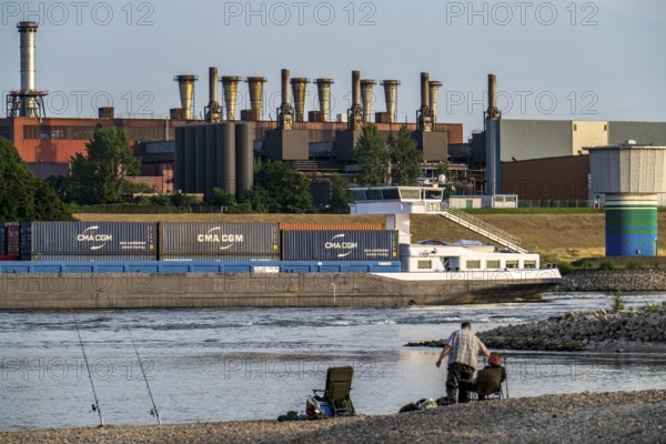 Industrial backdrop of the ThyssenKrupp Steel steelworks in Bruckhausen, on the Rhine, anglers in a