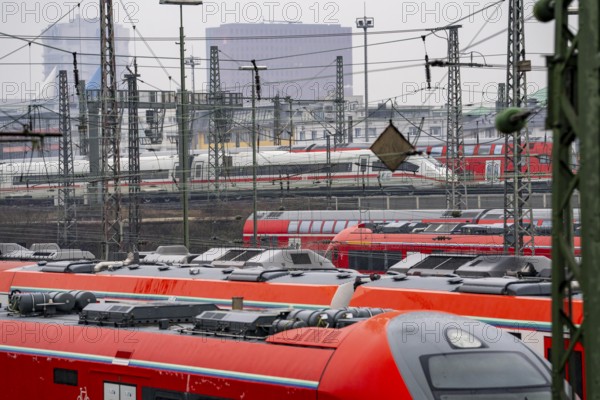 Railway tracks with regional trains and long-distance trains, ICE, after freezing rain, in front of