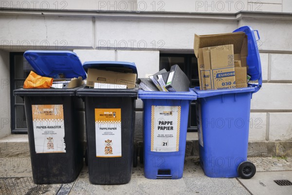 Symbolic photo. Overfilled paper bins on a street in Berlin Mitte. Berlin, 04.06.2024