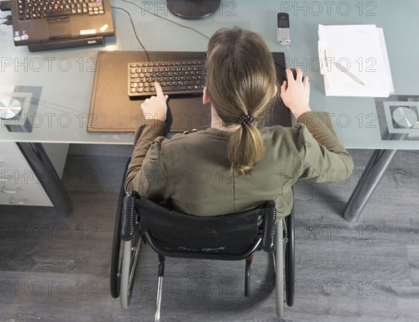Young woman in a wheelchair at her workplace, Berlin, 18/01/2017