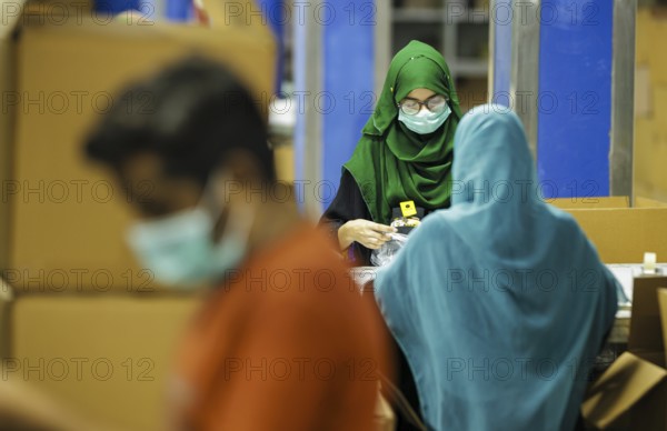 Employees of Inter Market Knit Private Limited producing socks. Lahore, 22.08.2024. Photographed on