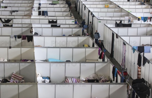Temporary rooms with beds are set up in an emergency shelter for refugees on 9 December 2015 in a