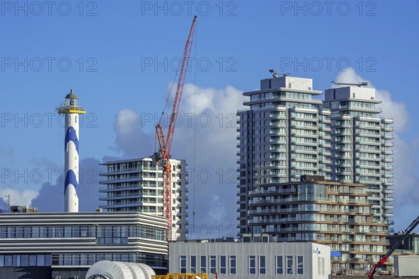 Lighthouse Lange Nelle and flat and apartments of the Oosteroever quarter along the harbour of