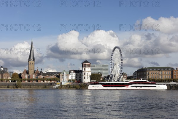 Rhine bank with St. Lambertus, castle tower and Ferris wheel, KD event ship MS Rheingalaxie,