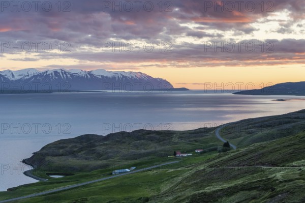 Snow-covered mountains, road and farm, sunrise over Eyjafjörður or Eyjarfjörður or Eyjafjördur,