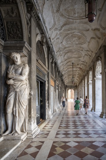 Statue of a woman in the arcades of St Mark's Square, Venice, Veneto, Italy, Europe