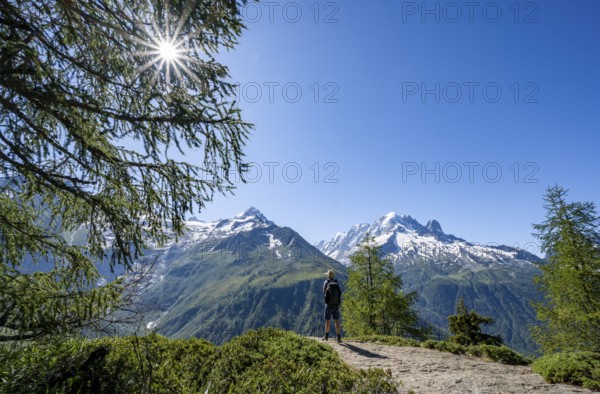 Mountaineer on hiking trail, mountain panorama with glaciated mountain peaks, Aiguille Verte, hike