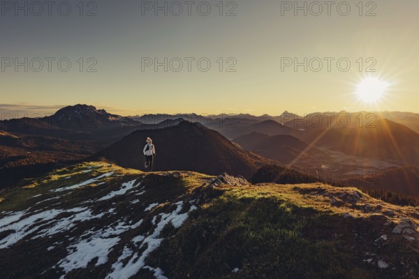 Trail running in autumn on the Jochberg on Lake Walchensee against the wonderful backdrop of the
