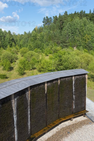 Curved wooden Kneipp wall in the middle of a wooded landscape, brine, graduation tower, spa town of