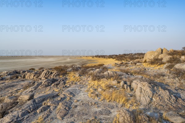 View over round rocks from Kubu Island (Lekubu) to the salt pan, at sunrise, Sowa Pan, Makgadikgadi