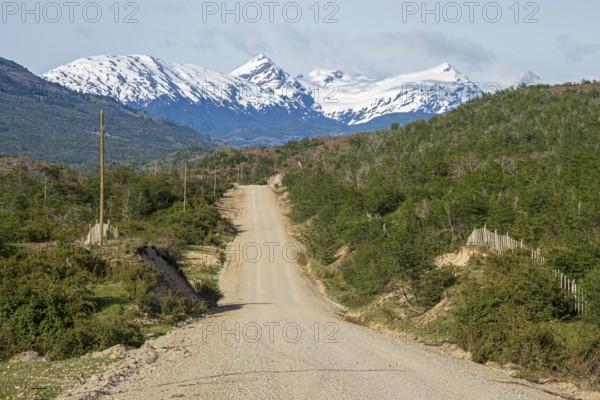 Road Carretera Austral north of Cochrane, gravel road in front of snowcovered mountains, Patagonia,