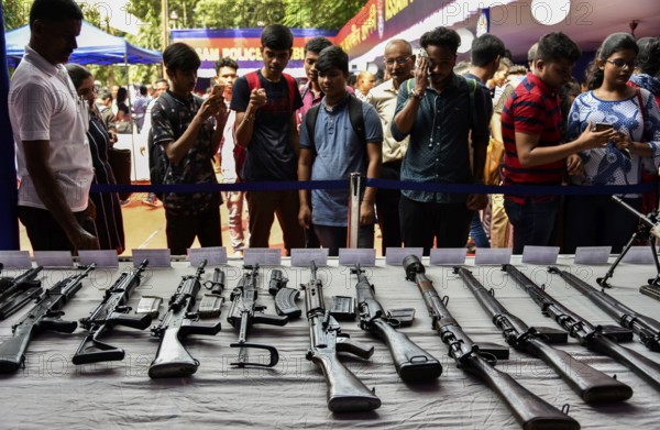 Students visit an arms stall during an exhibition to commemorate Assam Police Day, in Guwahati,