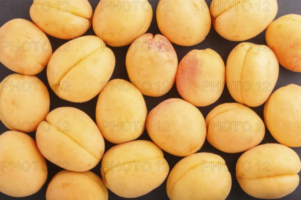 Apricots pattern on black background, top view, flat lay