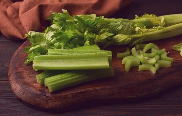 Fresh bunch of celery, top view, no people, on a dark background