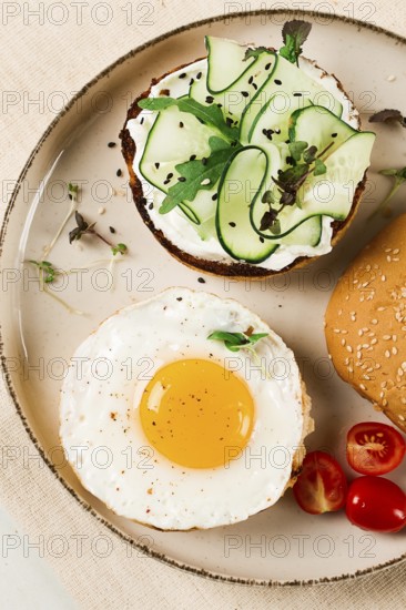 Assortment of sandwiches, white bread, fried egg, cream cheese and cucumber, capelin caviar, sesame