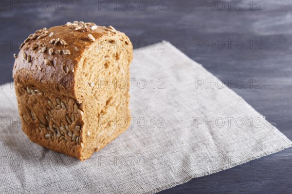 Cut rye bread on linen napkin. close up
