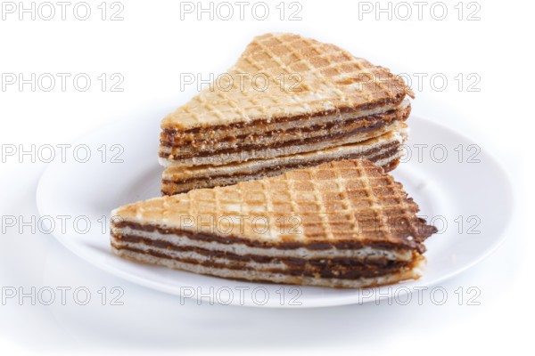 Waffle sandwiches with boiled condensed milk in plate isolated on white background. closeup