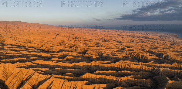 Landscape of eroded hills at Lake Issyk Kul, Badlands at sunrise, aerial view, Canyon of the