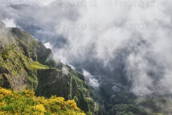 Aerial drone view of Curral das Freiras village from Miradouros do Paredao with blooming yellow
