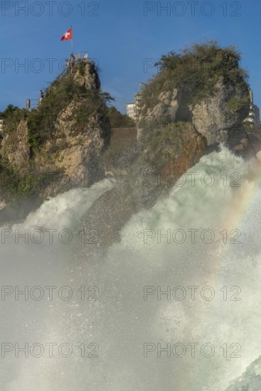 Rhine Falls seen from Laufen Castle, rocky island, Swiss flag, rainbow, spray, Canton of Zurich, on