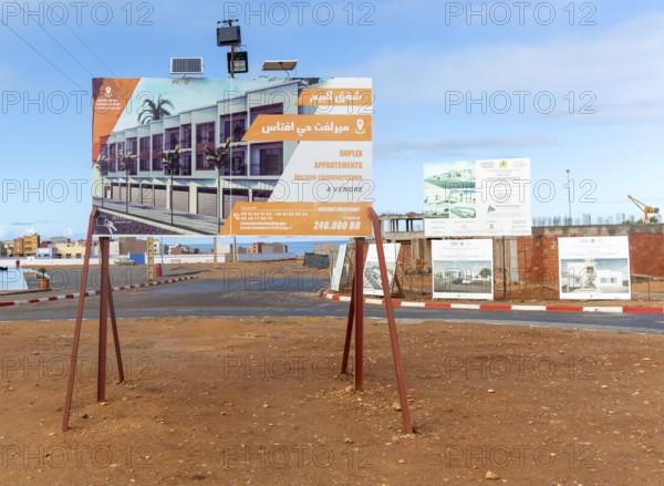 Estate agent real estate advertising sign for new duplex apartments, Mirleft, southern Morocco,