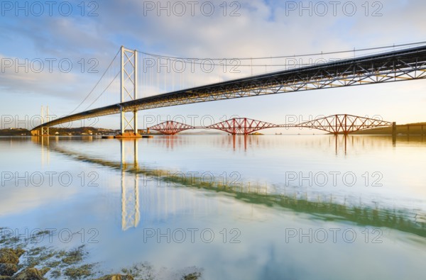 View of the Forth Road Bridge and the red railway bridge Forth Bridge at the Fírth of Forth estuary