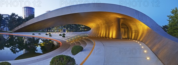Illuminated Porsche Pavilion in the evening, Autostadt, Volkswagen AG, Wolfsburg, Lower Saxony,