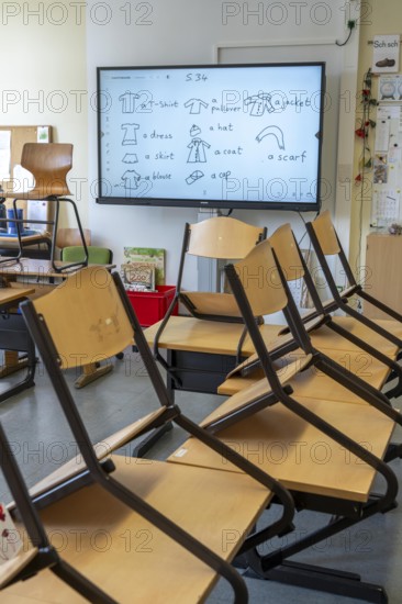Classroom of a fourth grade, after school, the building is older but in good condition, modern