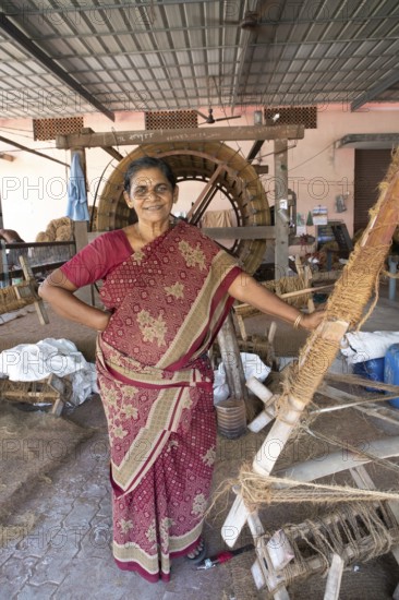 Indian worker, 59 years old, in the spinning mill of the Labourers Coir Mats and Mattings