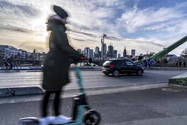 Skyline of Frankfurt am Main, skyscrapers, e-scooter rider on the Flößerbrücke, Hesse, Germany,