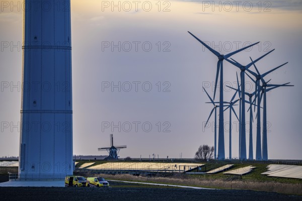 Windmill Poldermolen De Goliath stands between the high-tech wind turbines in Eemshaven, historic