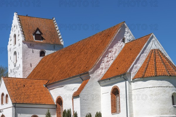 Lindelse Kirke, typical Danish church from 1830, whitewashed, red tiled roof, hill, steeple with