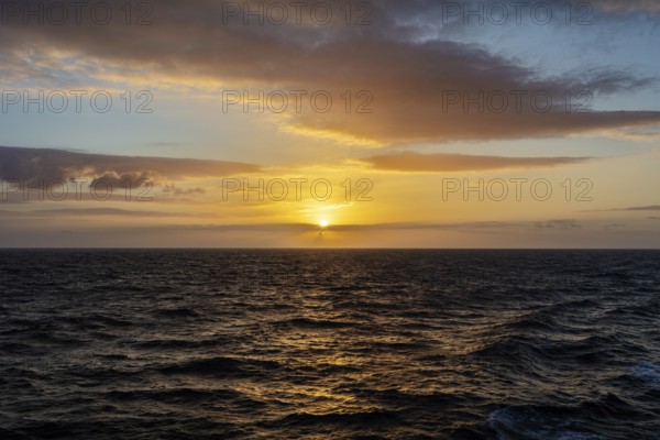 Peaceful sunset over the sea with bright orange sky and clouds, Celtic Sea