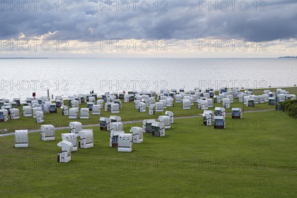 Beach chairs on the green beach, Dramatic sky over the North Sea, View from above, Norddeich, East