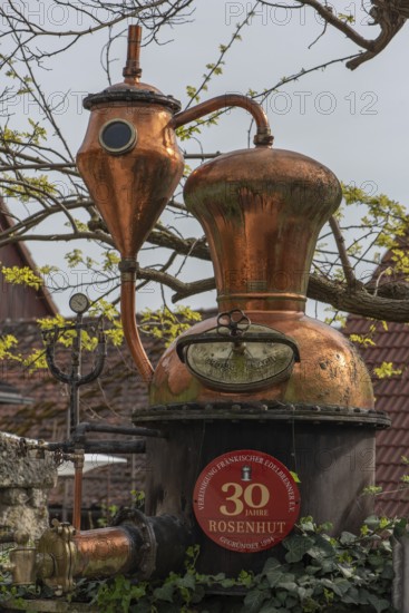 Distillery, distilling apparatus as an advertisement in front of a distillery, Lower Franconia,