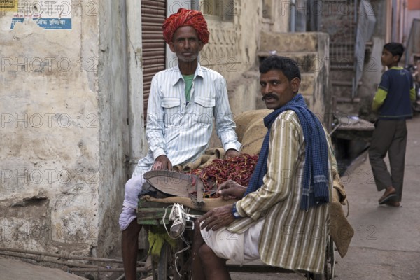 Men selling red peppers on street in Bundi, Rajasthan, India, Asia
