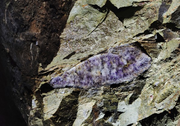 Minerals in the rock of the visitor gallery of the Steinkaulenberg gemstone mines, show mine in