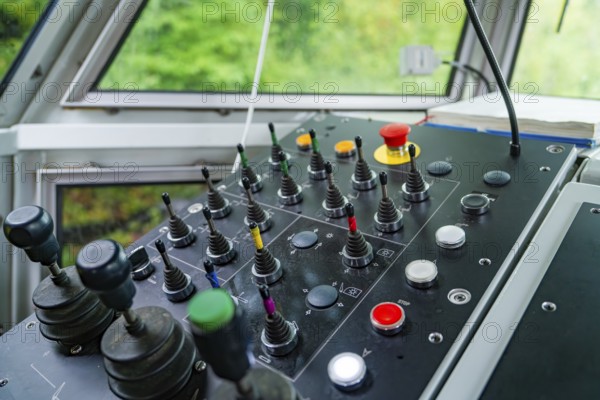 Control panel in bright surroundings, several levers and buttons in different colours, Hermann