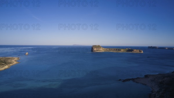 Drone shot, Remote island with wide view of the clear blue ocean and bright sky, Venetian Sea