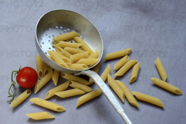 Pasta, Italian penne in a sieve ladle