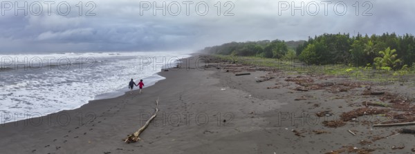 Two tourists on the beach, coast with rainforest, Tortuguero National Park, Costa Rica, Central