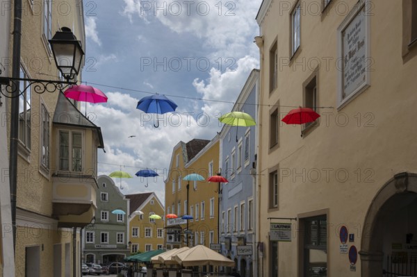 Colourful umbrellas stretched across the street, promising a prosperous and perfect life,