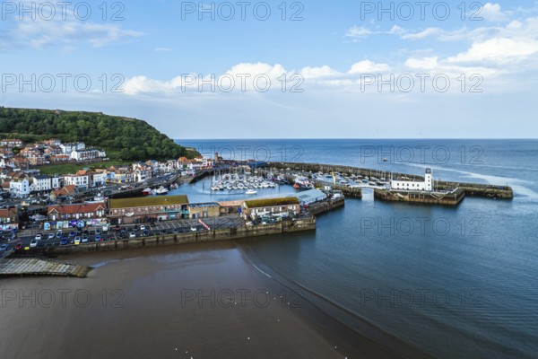 Scarborough Lighthouse and Harbour from a drone, Vincent Pier, Scarborough, North Yorkshire,