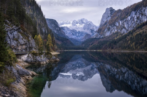 The Vordere Gosausee lake in autumn with a view of the Dachstein mountain range. The Gosaukamm on