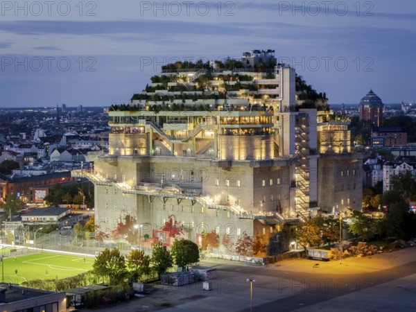 Aerial view of the Hamburg Bunker with green terraces and modern architecture in the evening